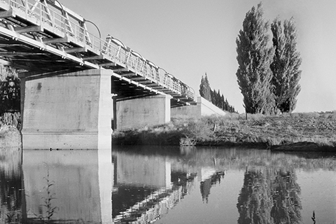 Old black and white photo of former Commonwealth Avenue Bridge captured from the side