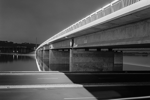 Black and white photo of Commonwealth Avenue Bridge captured from the side