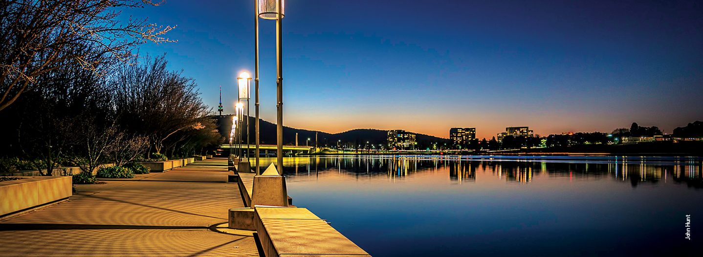 A night time photo of Lake Burley Griffin, Commonwealth Bridge, Acton and Regatta Point. 