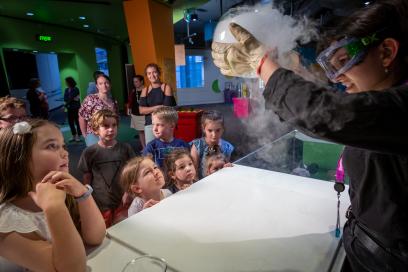 A group of children watch a science demonstration at Questacon with great interest.