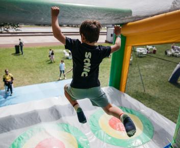 A child jumping off an inflatable obstacle.